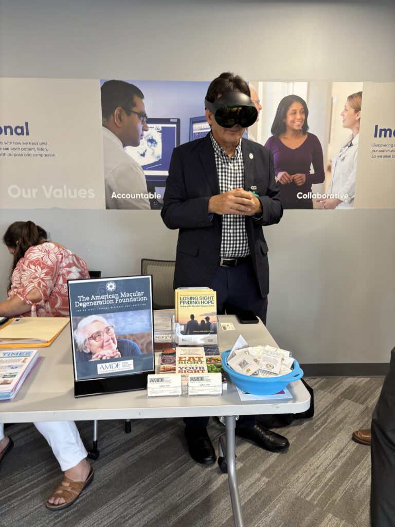 Matthew Levine, American Macular Degeneration Foundation wearing virtual reality goggles.
